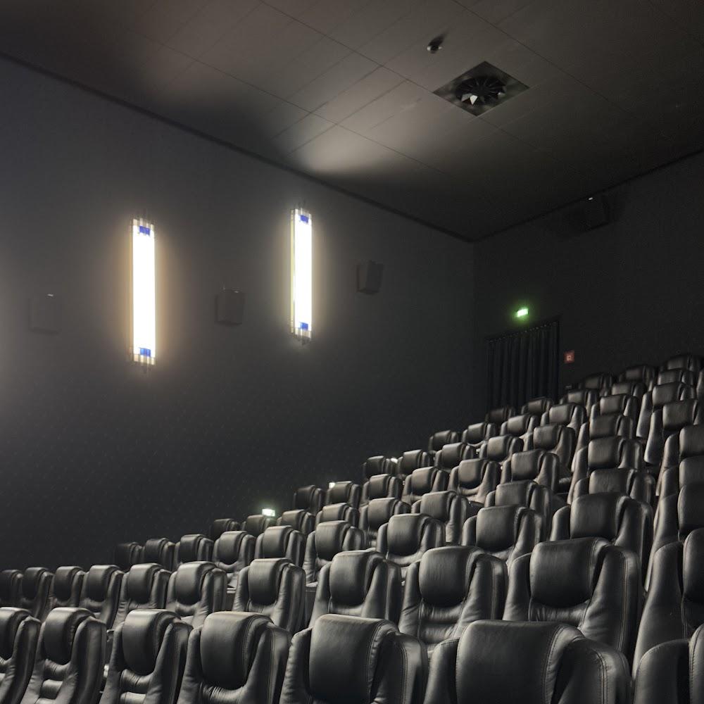 Empty movie theater with black seats.